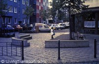 9. Cologne (Germany) slow speed allows space to be converted from carriageway to other uses, as in this example of a play and rest area outside a crossroads cafe. Materials and street furniture designed to complement townscape, and planting introduced. Note absence of traffic signs and road markings which are not needed in slow speed areas.