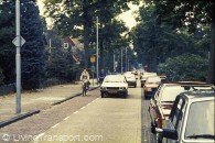 29. Eindhoven outer ring road (south). Dual 2-lane carriageway converted to dual 1-lane. Space reallocated to linear parking lane (for residents' cars), narrow main driving lane, and generous cycle lane/ occasional strip. Speed moderated by fact that large vehicles cannot pass cyclists and are thus limited to cyclist's speed, which in turn limits speed of entire platoon. This arrangement applies for about 400 metres. (pp 9,10,25,31,32,47)