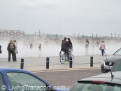 Bollards Bordelais 4 - spray rises from the water park by the river, and provides a distraction from the heavy traffic. In the open, bollards can have a stronger presence.       