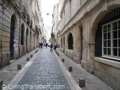 Bollards Bordelais 5 - Short stone bollards blend more easily with 18th century stone buldings. Shallow drainage channels are also in stone.          